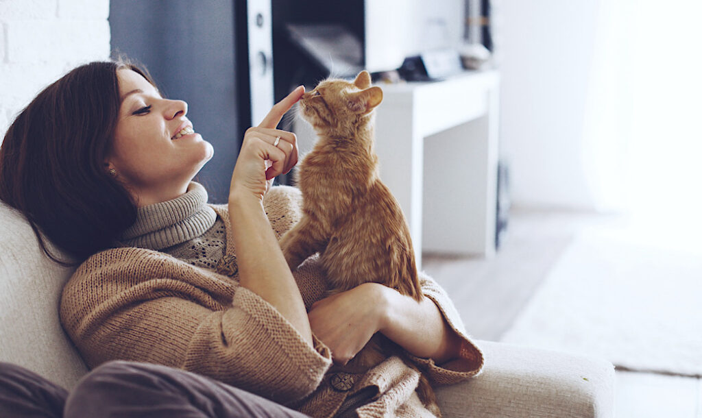 woman on couch with her kitten